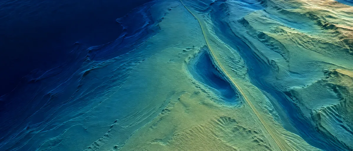 Illustrative later seabed with a new scour depression beside the asset corridor.